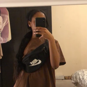 Svart Nike väska - Svart midjeväska som kan bäras hur man själv önskar.Använd en gång då det inte är riktigt min stil.Köpt för 300 kr i paris