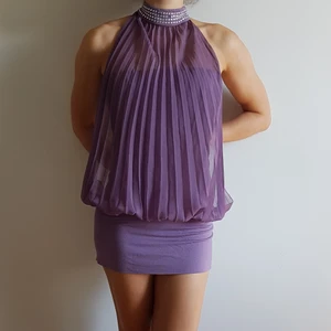 Ljulila klänning med strasschoker - Ljuslila klänning med strasschoker (en sten saknas, se tredje bilden) sänker priset därav, men går absolut att limma på en ny sten. 🙂 Pliserad chiffong framtill som knytes i nacken, öppen rygg. 💜 Klänning från BonPrix Collection. Storlek: 40/42.