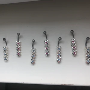 REA navelpiercing  - Navelpiercing med hänge.                                                • Modellen har två olika färger.                                   •De är tillverkade i kirurgiskt stål.                                      • Köp till en låskula i matchande eller annan färg om du vill.                                                                         •Stort antal på lager men är begränsat antal! Passa på att köp och köp hur många du vill! Endast 35kr styck. Frakten är den samma hur mycket du än beställer för!