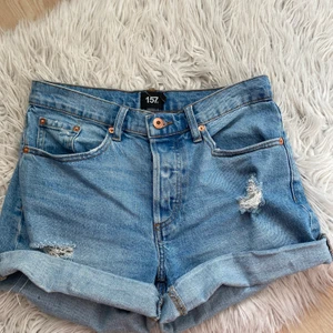 Shorts - Säljer ett par jeansshorts från lager 157. Jättefina och sparsamt använda. Har några slitningar och man kan justera hur högt man vill vika upp de. Du står för frakten!