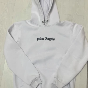 Palm angels hoodie - Säljer en skön palm angels hoodie med tryck både där fram och bak. Den är vit och väldigt clean. Priset är inte fastspikat och kan diskuteras. Frågor eller funderingar,skriv!
