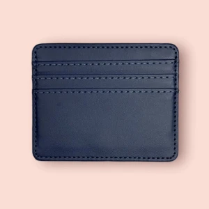 Marinblå korthållare - Slimmad och stilren korthållare i mörkblått skinn med plats för flera kort. Perfekt för dig som vill ha koll på korten utan att ta plats i fickan. Snygg och enkel design med diskreta sömmar.