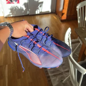 Blå och rosa Puma fotbollsskor strl 42 - Säljer ett par snygga Puma fotbollsskor i storlek 42. Skorna är nästan nya. Har använt dom fåtal gånger.