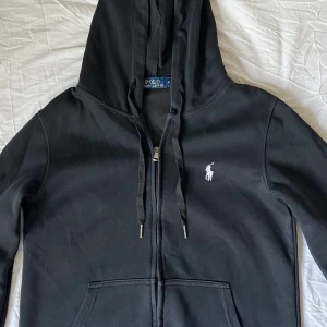 Svart hoodie från Polo Ralph Lauren - Svart hoodie från Polo Ralph Lauren i storlek M i barn storlek men är storleken XS. Skriv vid minsta funderingar. Pris går att diskutera!