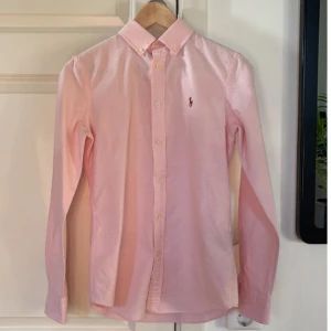 Rosa skjorta från Ralph Lauren - En rosa skjorta från Ralph Lauren i slim fit-modell, i storlek 2 (32). Bra skick.