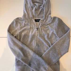 Juicy Couture grå zip up hoodie  - En grå zip up hoodie från Juicy Couture i storlek XS. Materialet är mjukt och perfect för chill dagar. Pris för en ny är 1300kr pà deras webbsida.