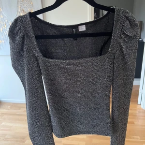 Glittrig topp - Säljer denna glittriga topp med puffärmar. Perfekt till festliga tillfällen. Har inga bilder på då den inte passar mig.🥰