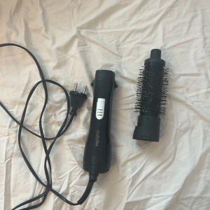 Svart varmluftsborste från BaByliss - Elektrisk varmluftsborste med rund borste och svart handtag. Perfekt för att styla och ge volym till håret. Borsten har täta piggar och handtaget har en silverfärgad knapp. Utrustad med sladd och EU-kontakt.