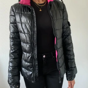 Svart dunjacka från Moncler - Moncler jacka.  svart, rosa insida. storleken är L, men skulle säga att sen sitter som S. dragkedjan är lite lös, saknar luvan.   pris kan diskuteras.  kan mötas i gävle-uppsala.  köparen står för frakten.  kontakta mig vid frågor eller fler bilder. 