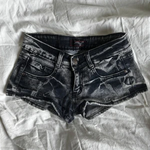 Lågmidjade jeansshorts svarta - Snygga svarta jeansshorts, låg midja och coola slitna detaljer. Köpta på second hand med prislappen kvar.