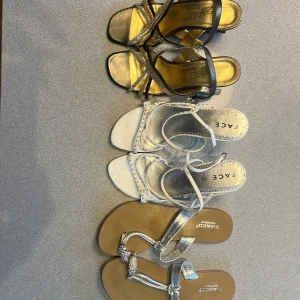Sommar skor - Säljer tre par skor: ett par guldiga klackar med svarta remmar från Zocico, ett par silvriga klackar med smala remmar från Face och ett par platta sandaler i silver med glittriga detaljer från Bianco. Alla är i storlek 36, säljer varje par för 100kr styck, eller alla för 250.