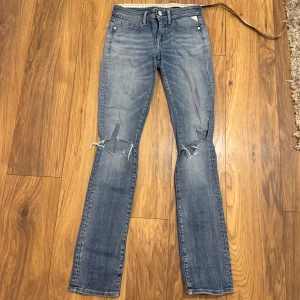 Replay 559 jeans med slitna knän - Blå Replay 559 jeans med raka ben och slitna detaljer vid knäna. Klassisk femficksmodell med normal passform och snygg tvätt. Liten grej på sista bilden visas. Hör av er för mått!