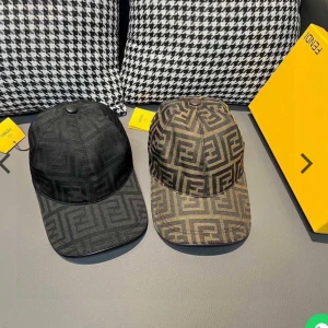 Svart keps med Fendi-monogram - Snygg svart keps från Fendi med diskret monogrammönster över hela kepsen. Klassisk böjd skärm och knapp på toppen. Tillverkad i ett slitstarkt tyg med exklusiv känsla. Perfekt accessoar för att lyfta din streetwear-look.