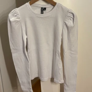 Vit långärmad topp från Pieces - Vit långärmad topp från Pieces med puffade axlar och rund halsringning. 🤍