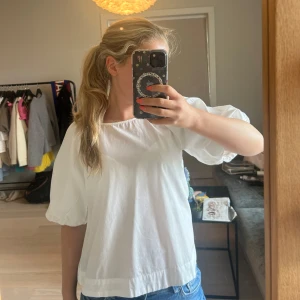 Vit blus med puffärm från H&M - Säljer en söt vit blus från H&M i storlek XS. Blusen har puffiga, korta ärmar. Superskönt material! 