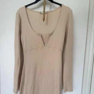 Beige ribbad långklänning från Nelly - Supersnygg beige ribbad långklänning från NLY Trend i storlek S. Klänningen har en tight passform med lång ärm och ger ultimat hour glas effekt. Klänningen har även en ett V vid brösten som är ställbart. Klänningen är aldrig använd. Skriv för fler bilder eller frågor💕💕