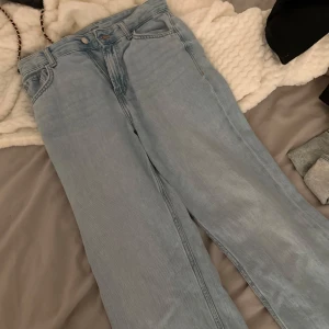 Bershka 90s wide ljusblå jeans - Säljer ett par Bershka 90s wide jeans i ljusblå denim. De har en riktigt bred passform och klassisk femficksdesign. Jeansen har hög midja och raka, vida ben för en avslappnad retrostil. Perfekta för dig som gillar 90-talsvibbar och loose fit.