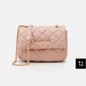 Quiltad rosa axelväska från Valentino - Supersnygg quiltad axelväska från Valentino i ljusrosa syntetmaterial. Väskan har guldfärgad kedjerem, lock med magnetlås och diskret logga framtill. Perfekt storlek för det viktigaste och ger en lyxig vibe till din outfit.kostar 1200,00kr