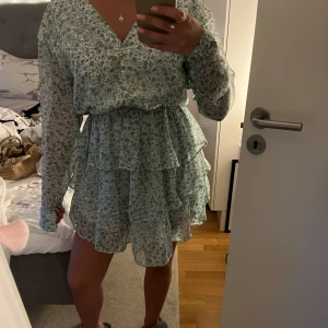 Volangklänning  - Gullig grön volang klänning från Gina. Dem har knappar på överdelen. Aldrig andvänt!