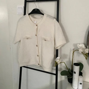 Vit stickad kofta med kort ärm och knappar - Superfin vit kofta med korta ärmar och snygga knappar framtill. Från Gina Tricot i storlek 170. Passar en xs / s. Väldigt fint skick 🩷