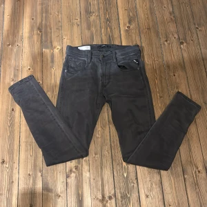 Grå jeans från Replay - Snygga grå jeans från Replay i modellen Anbass. De har en slim passform och är tillverkade i ett stretchigt material för extra komfort. Perfekta för en stilren look.