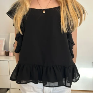Svart blus med volangdetaljer - Så fin!!