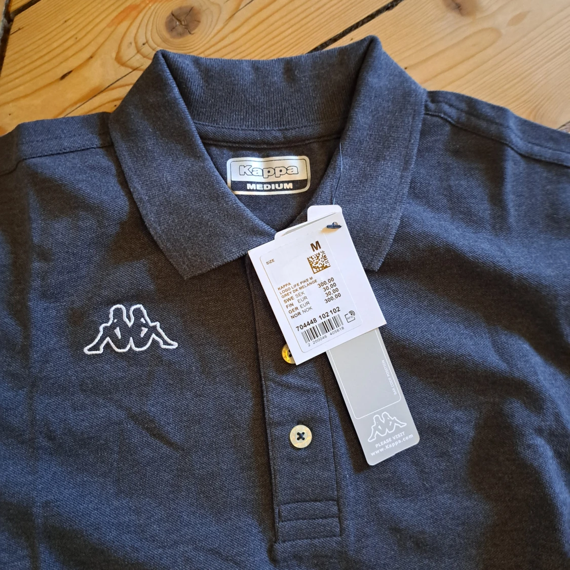 Mörkgrå pikétröja från Kappa