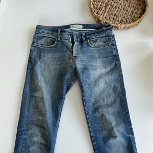 Blå jeans från Siviglia Denim - Snygga blå jeans från Siviglia Denim med klassisk femficksdesign och slitna detaljer. Jeansen har normal passform och raka ben, tillverkade i mjukt denimtyg med snygg tvättad look. Perfekta för dig som gillar en avslappnad och stilren vibe.