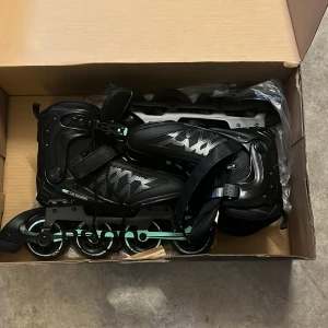 SOC TR90 rullskridskor  svart/mint strl 39 - Snygga Rullskridskor  från SOC i modellen TR900, storlek 39. Skorna är svarta med mintgröna detaljer och har snörning samt spänne för extra stabilitet. Perfekta för dig som vill cruisa runt med stil och komfort. Snygg design med mönstrade partier på sidan.