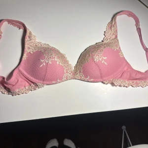 Intimissimi bh - Söt rosa bh med ljusbeige broderad spets framtill och fina spetskanter längs axelband och nederkant. Kuporna är lätt vadderade och har en mjuk struktur. Perfekt för dig som gillar romantiska och feminina underkläder.