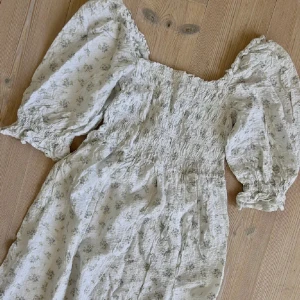 Blommig sommarklänning med puffärm - Supersöt ljus klänning med små blommor i lila och grönt. Endast använd 1 gång, super fin på sommaren🩷🩷