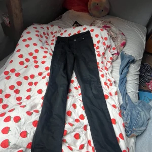 Svarta skinny jeans från Cheap Monday - Svarta jeans från Cheap Monday i klassisk skinny -modell. Byxorna har normal passform, fem fickor och snygga detaljer som Cheap Mondays ikoniska dödskalle på knappen. Perfekta för dig som gillar en tidlös look med lite edge.