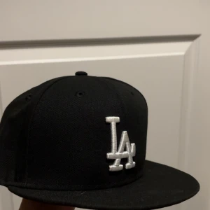 Svart LA keps från New Era - Använd max 2 gånger då jag snabbt bytte klädstil. Omkrets runt huvudet är 54,9cm, strl 6 7/8