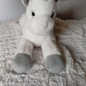 Unicorn toy - if you want to discuss the price or want more pics just send a message!! - It's a stuffed toy, white and fluffy, it had a small button inside it's right leg, on the top of it. If you press it the toy starts to play some simple notes and it's starts glowing. It works for kids anyway age.