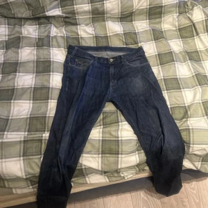 Blå jeans från Emporio Armani - Säljer ett par klassiska blå jeans från Emporio Armani. De köptes för 1800kr på Johnells. De är i ganska bra skick, lite slitna bara men inga hål eller liknande grejer. Det är normal passform på dom. Storlek i weist är 31 och längd 32. Säljer pga av att jag behöver rensa garderoben. 