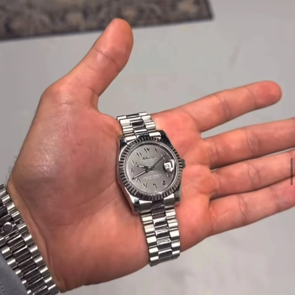 Silverfärgad klocka med länkarmband