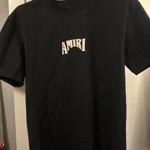 Amiri tshirt - Säljer en svart t-shirt från Amiri med vit logga på bröstet och stort grafiskt tryck med Amiri-text på ryggen. Tags medföljer!!
