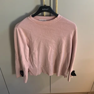 Ljusrosa stickad tröja med rosetter från Zara - Supersöt ljusrosa stickad tröja från Zara med svarta rosetter vid ärmsluten. Pris är diskuterbart❤️