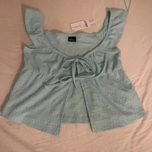 Ljusblå blus med knyt från Gina tricot - Supersöt ljusblå blus från Gina tricot med volangärmar och knyt framtill. 🩵ny med prislapp. Ordinarie pris: 259kr 