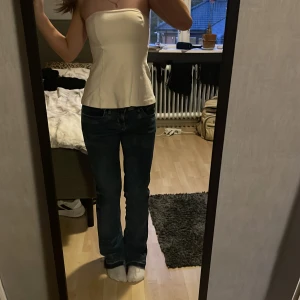 Blå jeansbyxor - Snygga blå jeansbyxor med låg midja och en klassisk straight stil. Perfekta för en avslappnad look. Midjemått är W27.