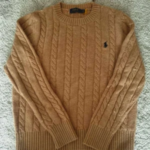 Stickad Ralph Lauren tröja  - Säljer en snygg beige stickad tröja från Ralph Lauren med kabelstickat mönster. Tröjan är skön och väldigt enkel att matcha till outfits och som vanligt med ett bra pris💫 storlek s-m💫nypris 1200💫