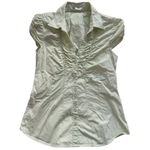 Blus från Flash - Pastel limegrön smockad blus med knappar, krage och kortärm 💚Lite lite mer grön än vad bilden visa. *lite missfärgning, märks knappt! (Se sista bilden!) Jag brukar ha strl XS/S i toppar för referens!