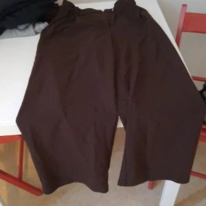 Bruna wide byxor - Säljer ett par bruna byxor med bred passform och croppad längd. Perfekta för dig som gillar en avslappnad stil och vill ha något bekvämt men ändå trendigt. Passar bra till sneakers eller sandaler.
