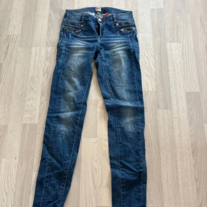 Blå jeans från ONLY - Snygga blå jeans från ONLY med en klassisk femficksdesign och dragkedjor framtill. De har en lätt tvättad look som ger en cool och avslappnad stil. Perfekta för en casual outfit.