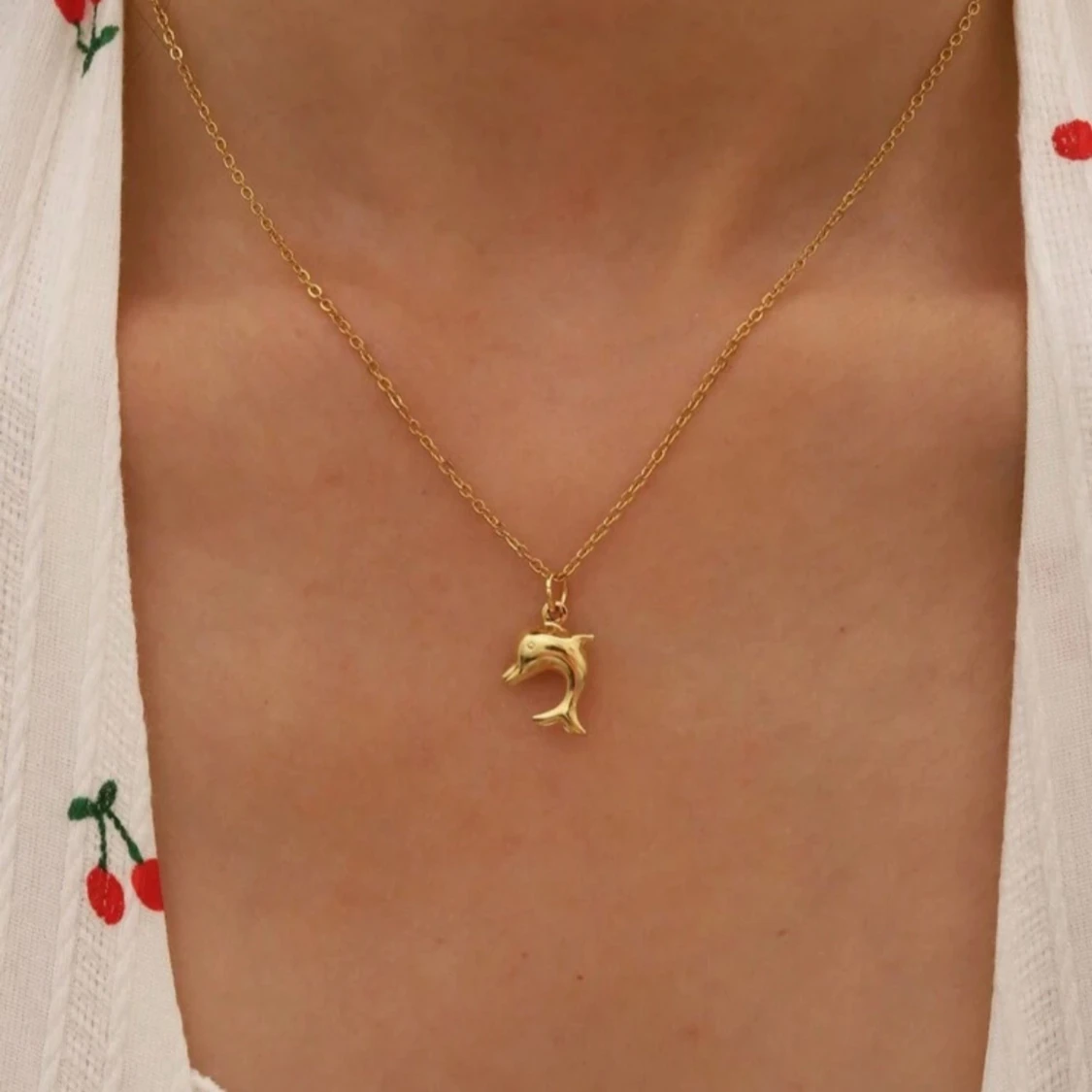 Guldigt halsband med delfinberlock