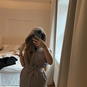 Beige dunväst med huva och bälte - Passar xxs - s.