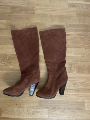 Bruna mockastövlar med klack - Snygga bruna stövlar i mocka med hög klack och rund tå. I nyskick! 