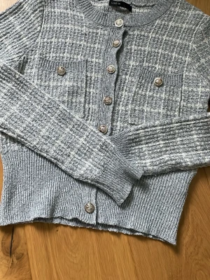 Grå/vit kofta  - En kofta med knappar som är lite rutig, ljus, grå och vit! ☺️