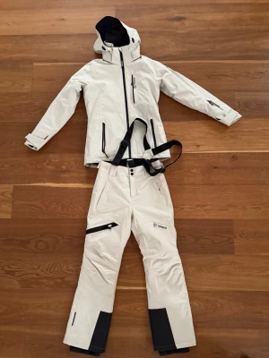 Skidställ från tenson - Säljer beige skidställ från tenson i mycket bra skick, som endast har använts några gånger! Det finns en liten fläck vid benet under dragkedjan (se bild) som eventuellt kan gå bort i tvätten. Nypris 4000kr 