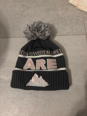 Åre mössa - Grå/ rosa Åre mössa från Robin Ruth, nyskick